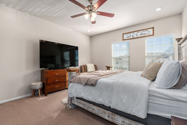 bedroom with ceiling fan and light colored carpet