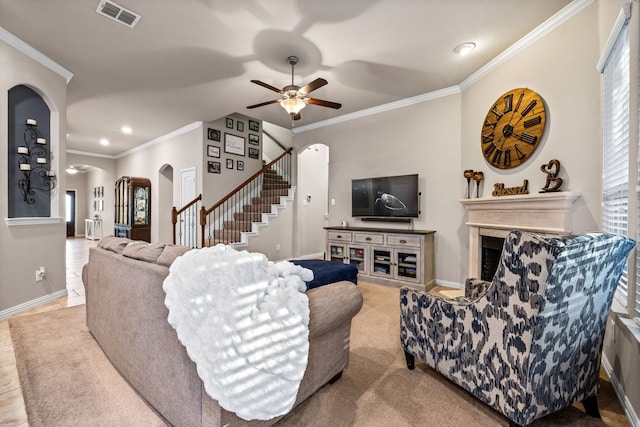 living room featuring crown molding, ceiling fan, and light colored carpet