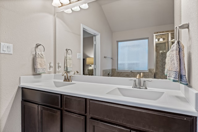 bathroom with vanity and lofted ceiling