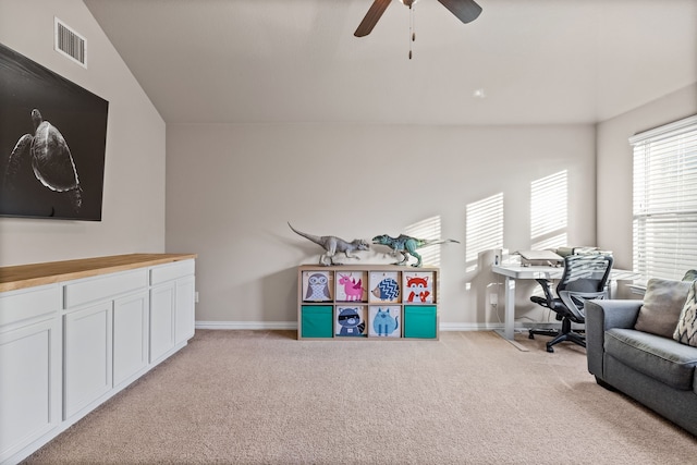 recreation room with ceiling fan, light colored carpet, and vaulted ceiling