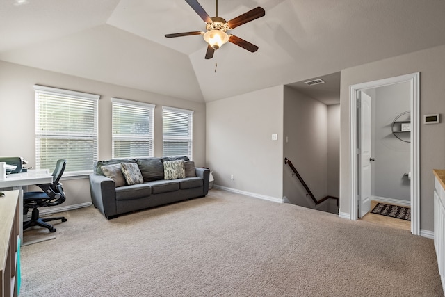 interior space with ceiling fan, light carpet, and vaulted ceiling