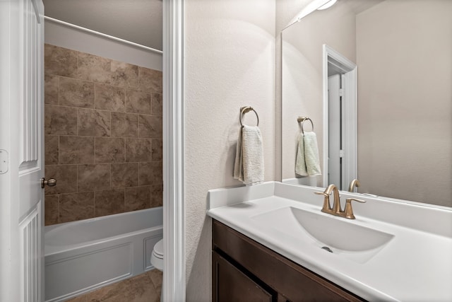 full bathroom with vanity, toilet, and tiled shower / bath