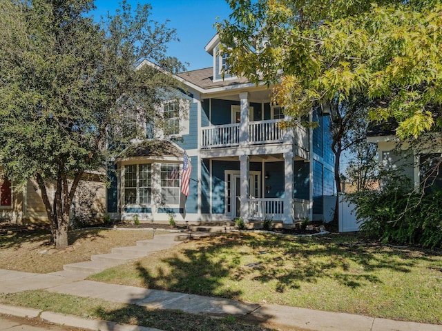 view of front of property with a balcony and a front yard