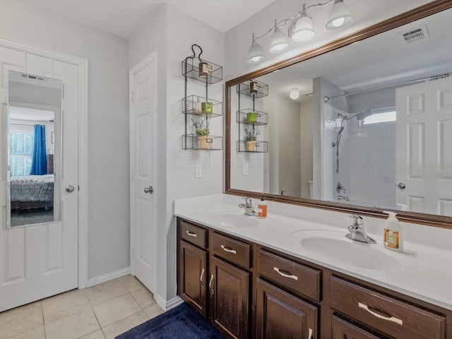 bathroom with tile patterned floors, plenty of natural light, toilet, and vanity