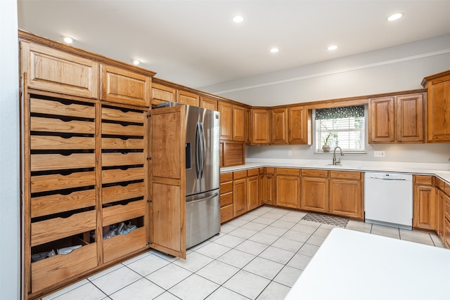 kitchen featuring stainless steel fridge with ice dispenser, dishwasher, light tile patterned floors, and sink