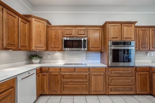 kitchen featuring appliances with stainless steel finishes and light tile patterned flooring