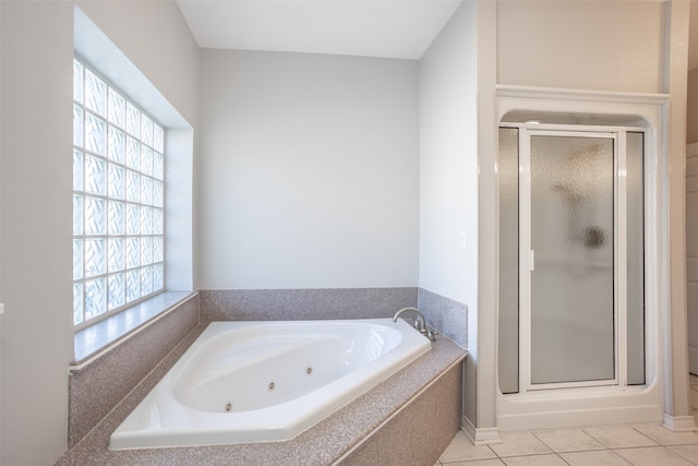 bathroom featuring tile patterned flooring and independent shower and bath