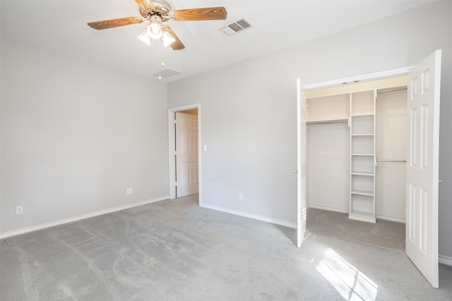 unfurnished bedroom with carpet, ceiling fan, and a closet