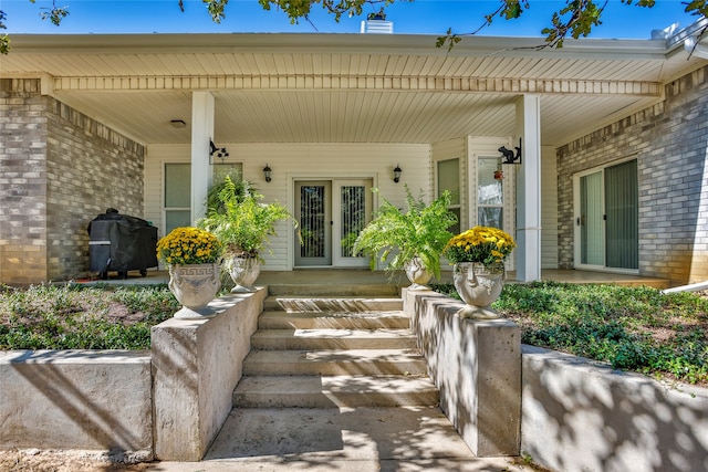 doorway to property with a porch