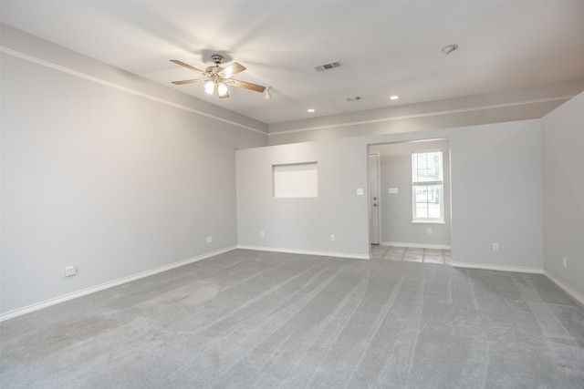 carpeted spare room with ceiling fan