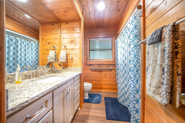 bathroom with hardwood / wood-style flooring, vanity, wood walls, and wood ceiling