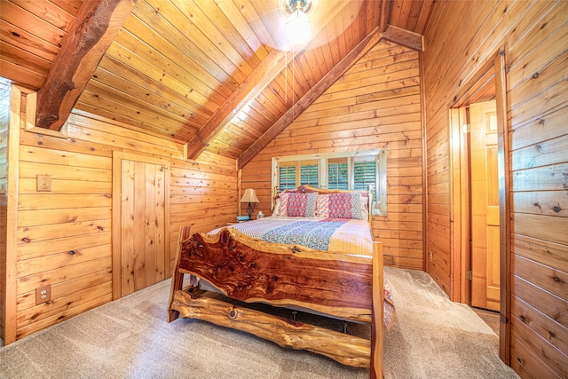 carpeted bedroom featuring lofted ceiling with beams, wooden walls, and wooden ceiling