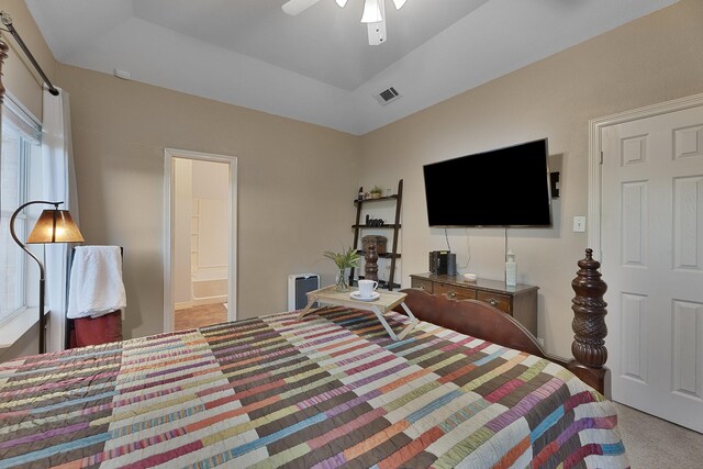 bedroom featuring light carpet, connected bathroom, and ceiling fan