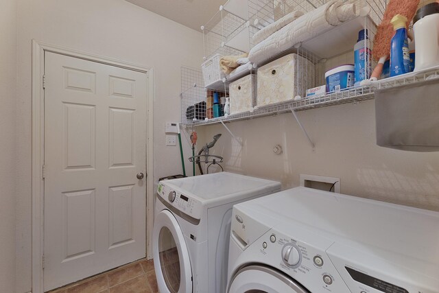 washroom with washing machine and dryer and light tile patterned floors