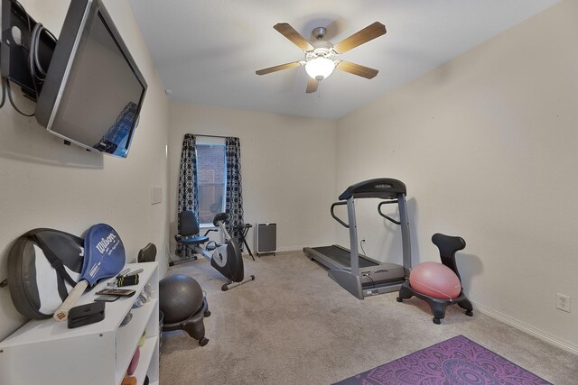 exercise room featuring light carpet and ceiling fan