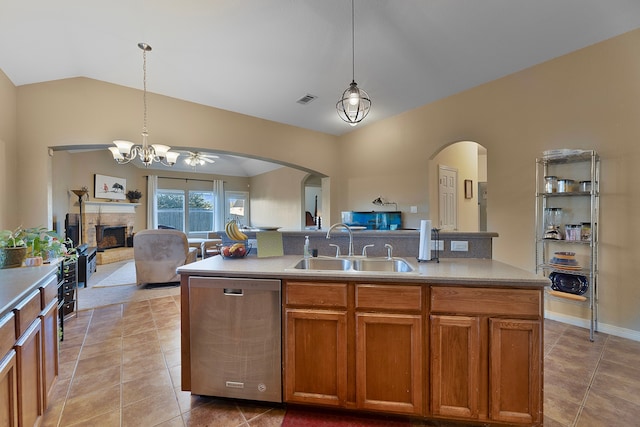 kitchen with pendant lighting, vaulted ceiling, dishwasher, and sink