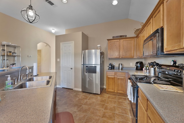 kitchen featuring black appliances, sink, vaulted ceiling, light tile patterned floors, and decorative light fixtures