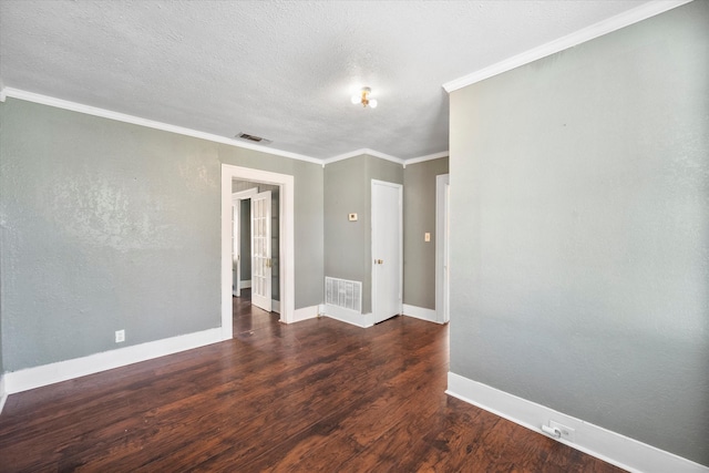 spare room featuring a textured ceiling, dark hardwood / wood-style floors, and crown molding