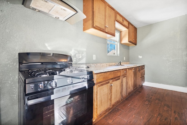 kitchen featuring range hood, black range with gas cooktop, dark hardwood / wood-style floors, and sink