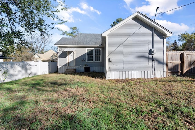 back of property featuring a yard