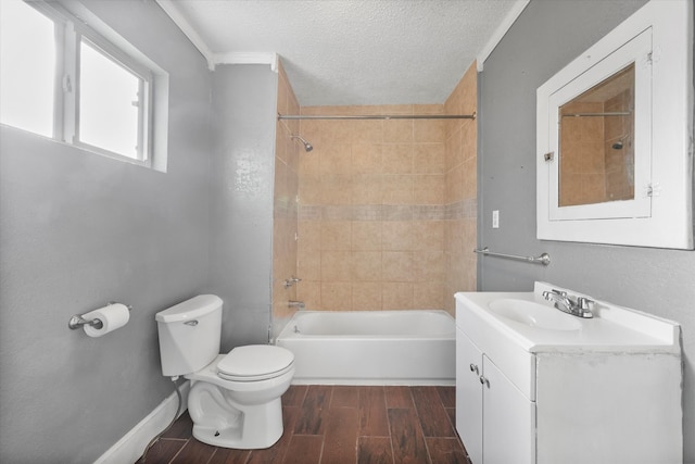 full bathroom with vanity, a textured ceiling, hardwood / wood-style floors, toilet, and tiled shower / bath