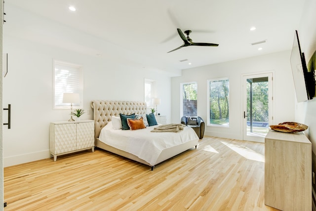 bedroom with hardwood / wood-style floors, access to outside, and ceiling fan