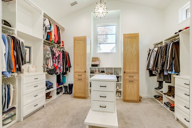 spacious closet with light colored carpet and lofted ceiling