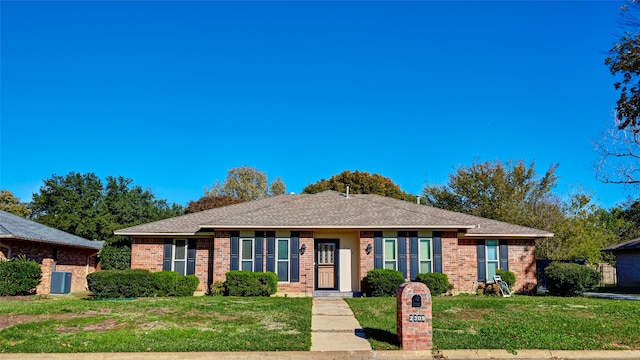 ranch-style home with central AC and a front yard