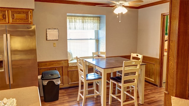 dining room with ceiling fan, light wood-type flooring, and ornamental molding