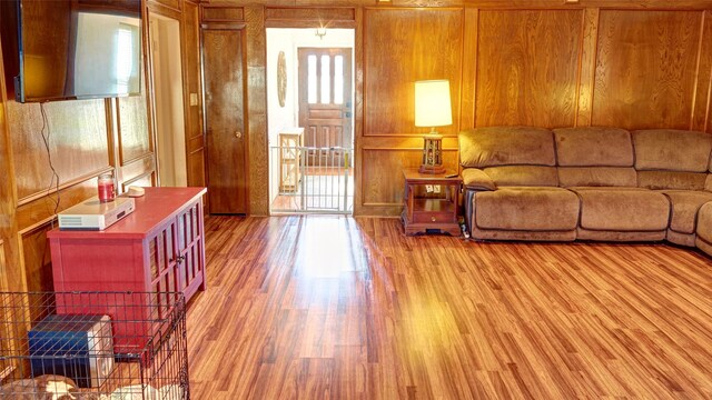 living room featuring wood walls and wood-type flooring