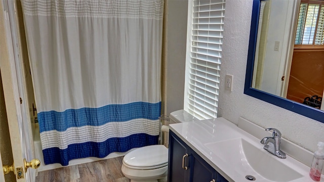 full bathroom featuring vanity, hardwood / wood-style flooring, toilet, and shower / tub combo with curtain