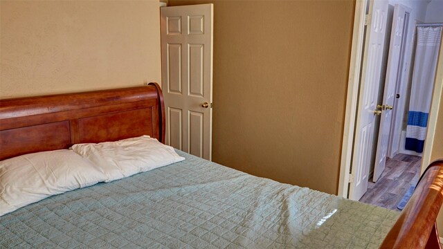 bedroom with hardwood / wood-style flooring