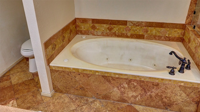 bathroom with a relaxing tiled tub and toilet