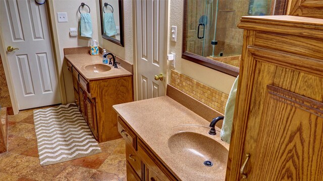 bathroom featuring vanity and an enclosed shower