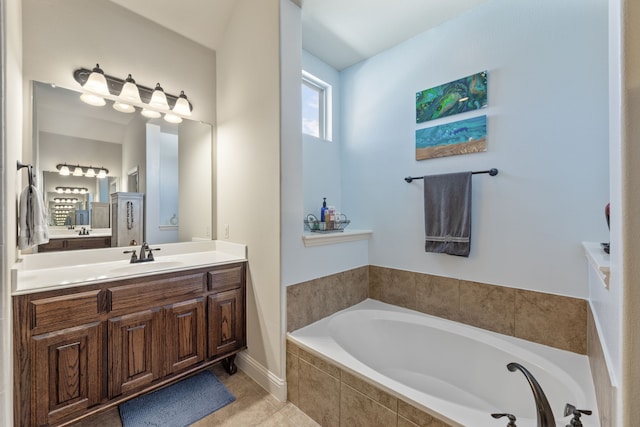 bathroom featuring tiled bath and vanity