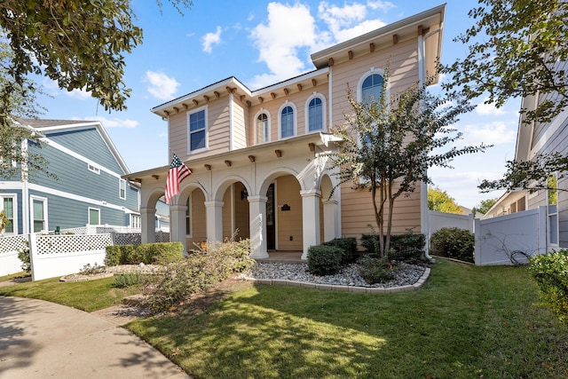 view of front of property with covered porch and a front yard