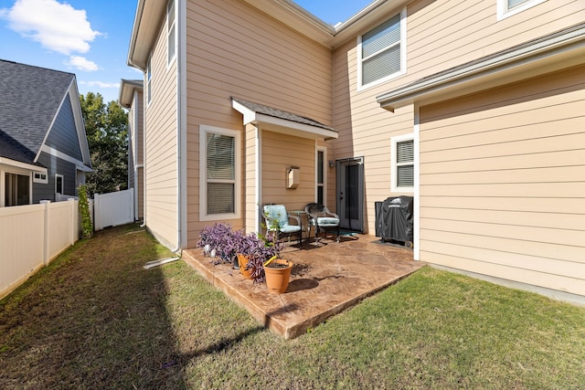 back of property featuring a yard and a patio