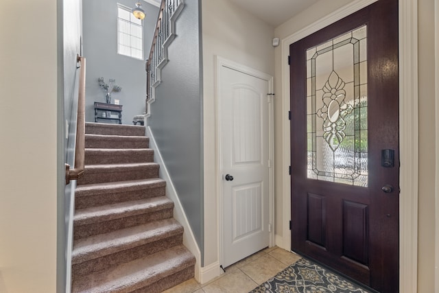 foyer entrance with light tile patterned floors