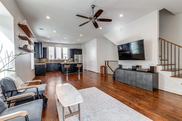 living room with dark hardwood / wood-style floors and ceiling fan