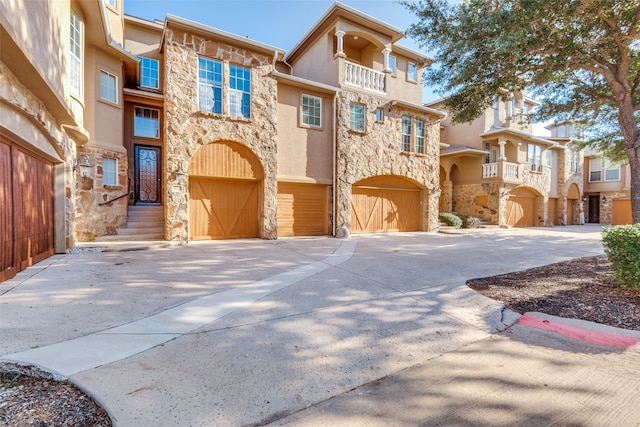 multi unit property with a garage and a balcony