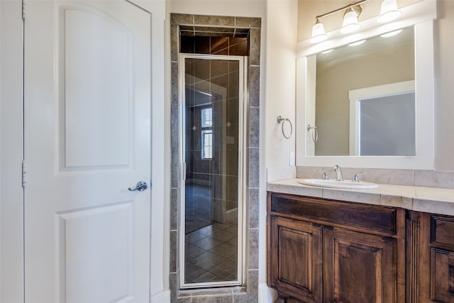 bathroom featuring vanity and an enclosed shower