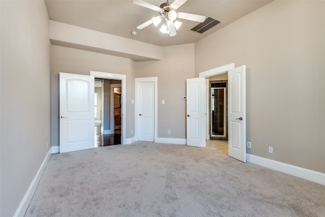 unfurnished bedroom featuring ceiling fan and light carpet