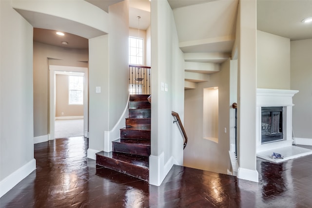 staircase with hardwood / wood-style floors and plenty of natural light