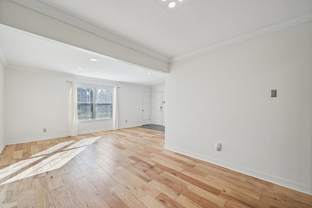 spare room with light hardwood / wood-style floors and crown molding