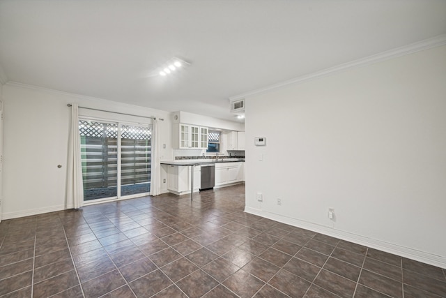 unfurnished living room featuring dark tile patterned flooring and ornamental molding