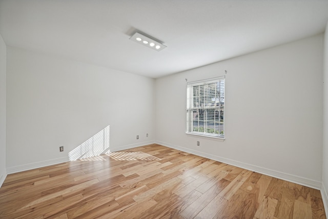 spare room featuring light hardwood / wood-style floors