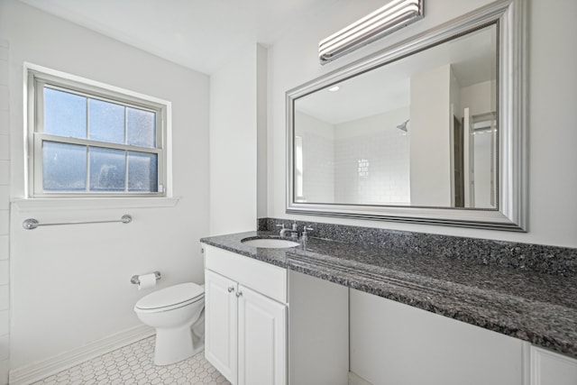 bathroom featuring walk in shower, tile patterned flooring, vanity, and toilet