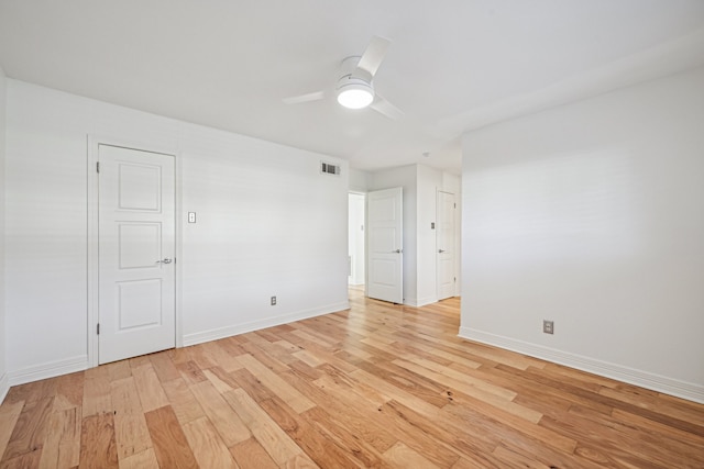 empty room featuring ceiling fan and light hardwood / wood-style floors