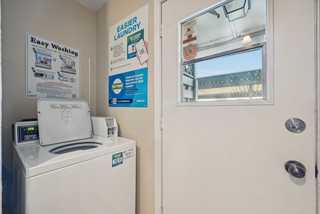 clothes washing area with washing machine and clothes dryer