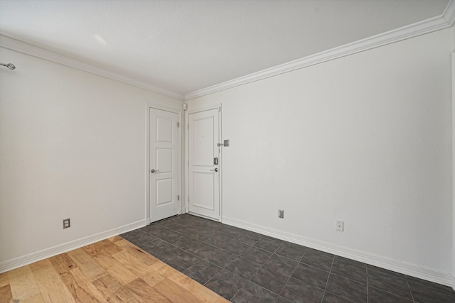 spare room with dark hardwood / wood-style floors and ornamental molding